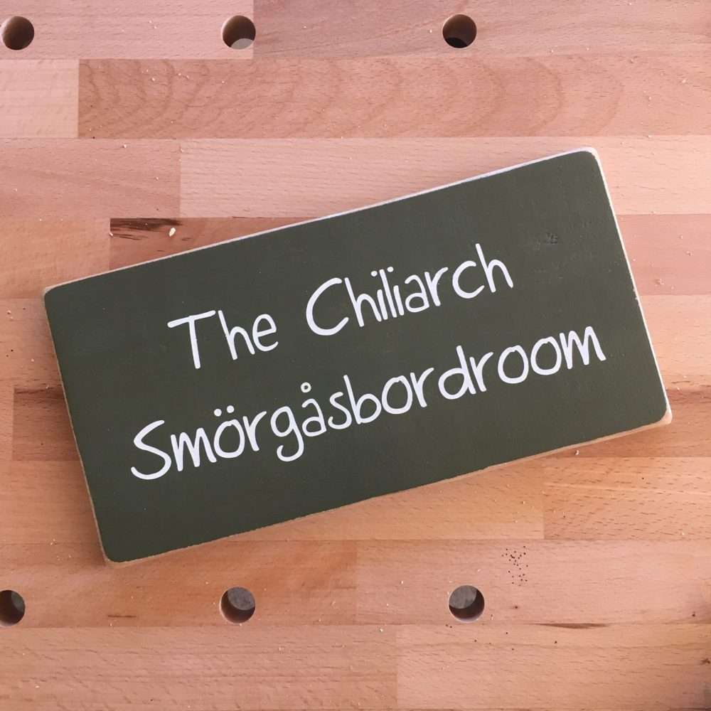 Painted green wooden sign